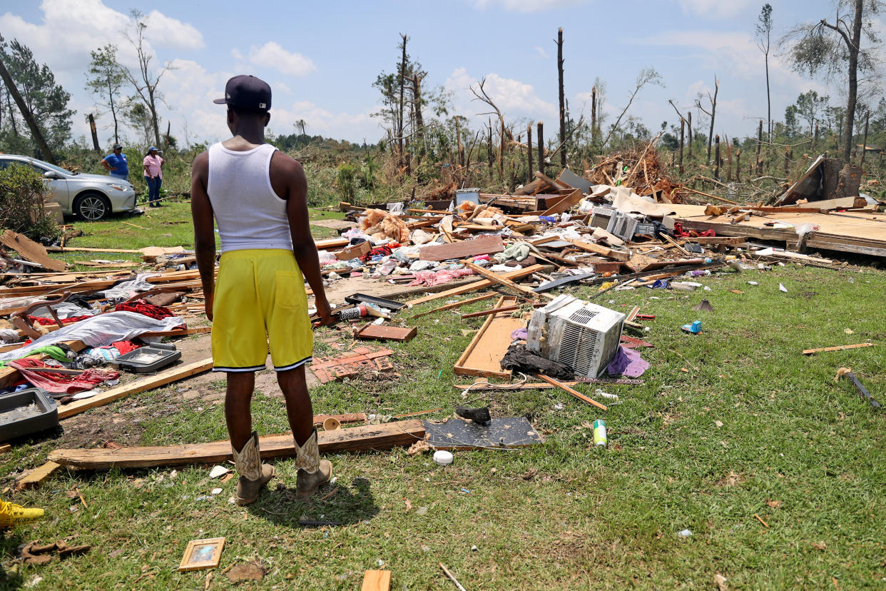 Adrian Cole shows where he found the body of his neighbor, identified by family as George Jean Haynes, outside their home after a tornado struck off Country Road 16, on June 19, 2023 in Louin, Mississippi. (Michael DeMocker/Getty Images)