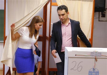 Gabor Vona, the chairman of the far-right Jobbik party and his wife Krisztina leave a ballot booth to vote on the European Parliamentary elections in Budapest May 25, 2014. Reuters/Laszlo Balogh