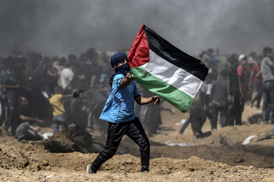 A Palestinian protestor waves his national flag during a demonstration along the border with Israel east of Jabalia in the central Gaza Strip on June 8, 2018. (Photo: Mohammed Abed/AFP/Getty Images)