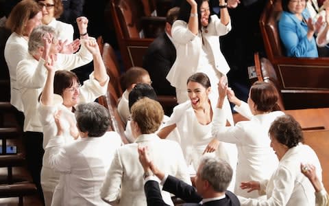 A group of Democratic women cheer as Mr Trump lauds a historic number of women in Congress - Credit: Chip Somodevilla/Getty