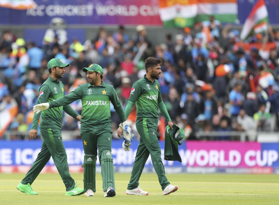 Pakistan's captain Sarfaraz Ahmed, center, and teammates leave at the end of India's innings during the Cricket World Cup match between India and Pakistan at Old Trafford in Manchester, England, Sunday, June 16, 2019. (AP Photo/Aijaz Rahi)