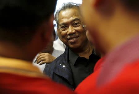 Malaysia's suspended Deputy Prime Minister Muhyiddin Yassin greets supporters as he arrives at Kuala Lumpur International Airport in Sepang, Malaysia, March 1, 2016. REUTERS/Olivia Harris