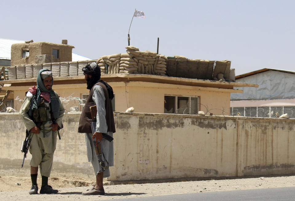 Taliban fighters stand guard inside the city of Ghazni, southwest of Kabul, Afghanistan, Friday, Aug. 13, 2021. The Taliban have completed their sweep of the country’s south on Friday, as they took four more provincial capitals in a lightning offensive that is gradually encircling Kabul, just weeks before the U.S. is set to officially end its two-decade war. (AP Photo/Gulabuddin Amiri)