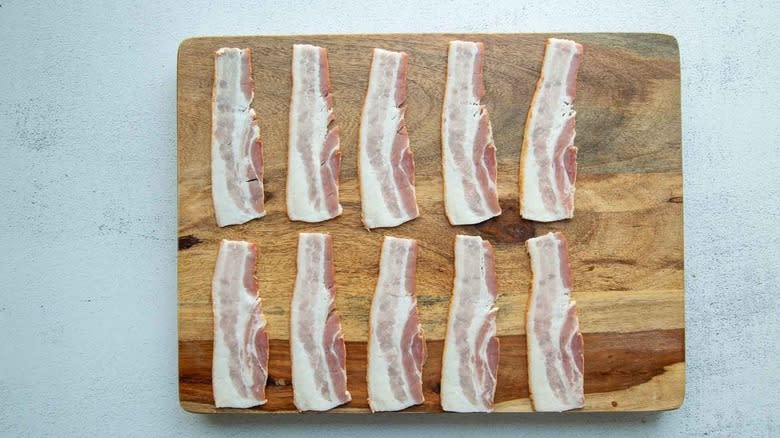 bacon strips on wooden board