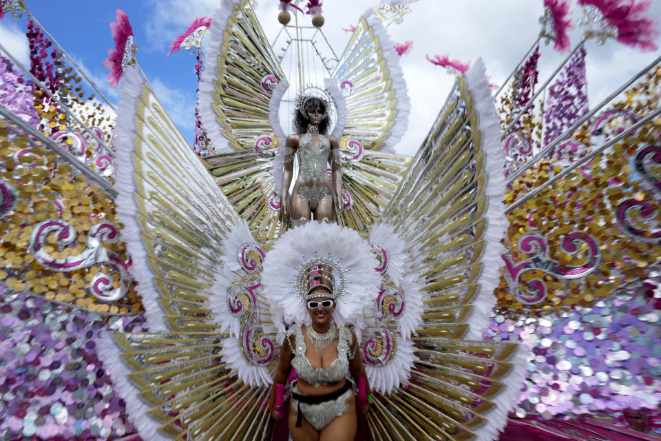 A masquerader performs during the Caribbean Carnival parade in Toronto, Canada, Saturday, July 30, 2022. The 55th annual parade returned to the streets after the COVID-19 pandemic cancelled it for two years in a row. (AP Photo/Kamran Jebreili)