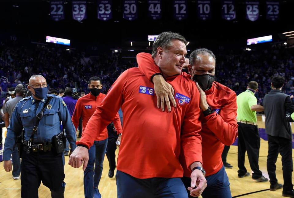 Kansas coach Bill Self, left, who lost his father Bill Sr., just days ago, is congratulated by assistant coach Kurtis Townsend after the Jayhawks stormed back to beat rival Kansas State, 78-75 Saturday at Bramlage Coliseum in Manhattan. KU trailed nearly all of the game, but managed to dig deep and come away with the win.