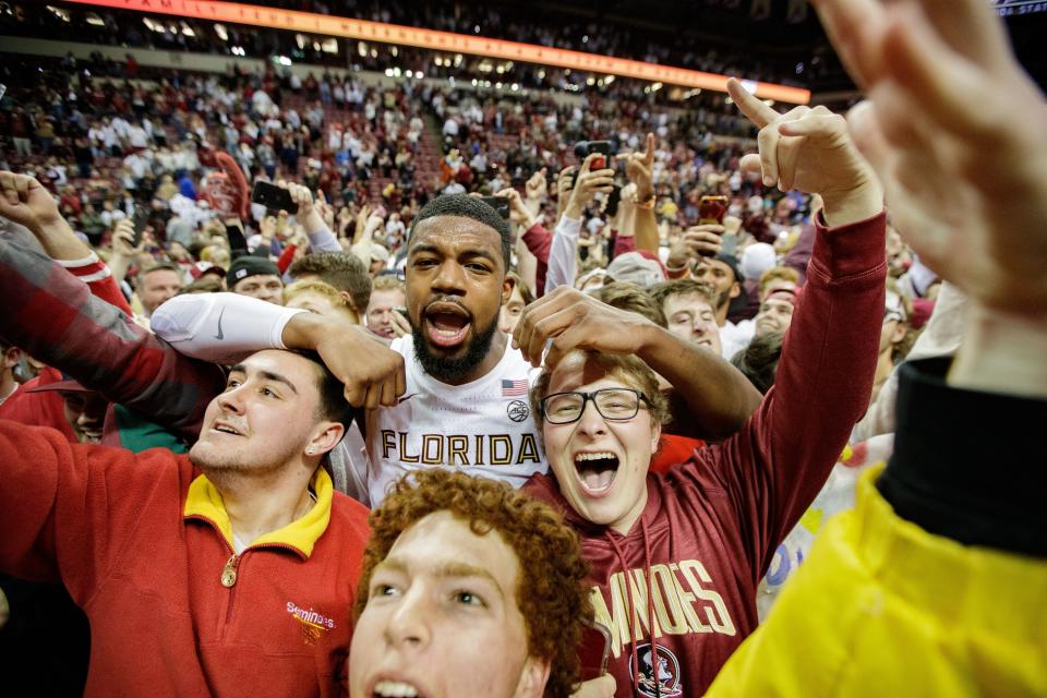 Florida State Seminoles forward Malik Osborne (10) celebrates with fanswho stormed the court after the Seminoles defeated the Duke Blue Devils 79-78 in overtime at the Donald L. Tucker Civic Center on Tuesday, Jan. 18, 2022.