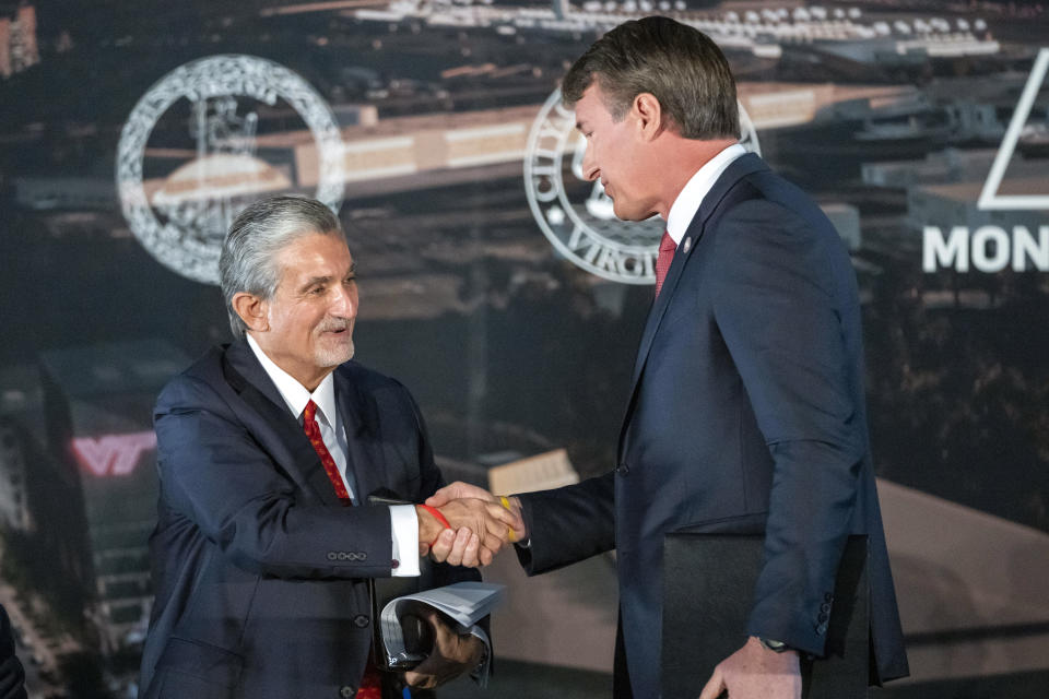 FILE - Ted Leonsis, left, owner of the Washington Wizards NBA basketball team and Washington Capitals HNL hockey team, shakes hands with Virginia Gov. Glenn Youngkin as they announce plans for a new sports stadium for the teams, Wednesday, Dec. 13, 2023, in Alexandria, Va. Negotiations to lure the Capitals and Wizards to northern Virginia have “ended” and the proposal to create a development district with a new arena for the teams "will not move forward,” the city of Alexandria said in a statement Wednesday, Mach 27, 2024. (AP Photo/Alex Brandon, File)