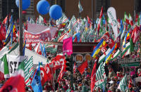 Demonstrators take part in a march organized by Italy's main labor unions, in Rome's St. John Lateran square, Saturday, Oct. 16, 2021. The march was called a week after protesters, armed with sticks and metal bars, smashed their way into the headquarters of CGIL, a left-leaning union, and trashed its office, during a demonstration to protest a government rule requiring COVID-19 vaccines or negative tests for workers to enter their offices. (AP Photo/Andrew Medichini)