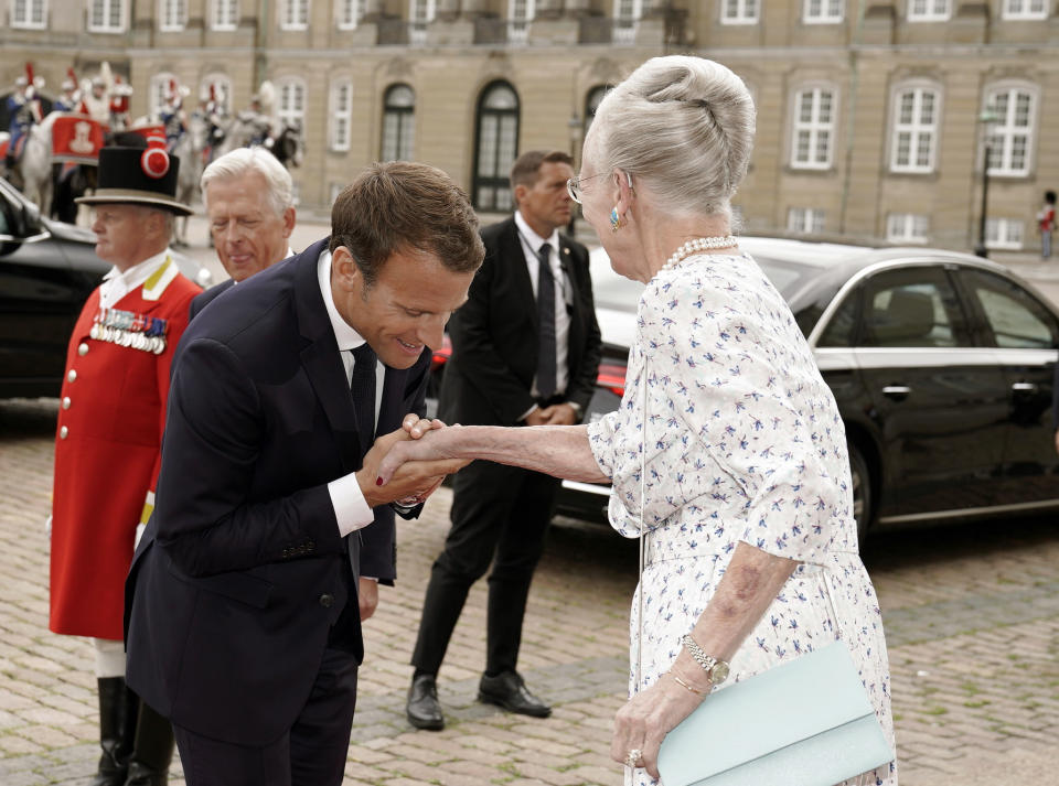 French President Emmanuel Macron , left, shakes hands with Denmark's Queen Margrethe as he arrives with his wife Brigitte at Amalienborg Castle in Copenhagen Denmark, Tuesday Aug. 28, 2018. Macron is on a two-day visit, hoping to build the relationships he needs to push France’s agenda of a more closely united European Union. (Martin Sylvest/Ritzau via AP)