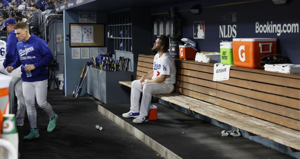 Dodgers pitcher Clayton Kershaw sits by himself in the dugout after being pulled from the game.