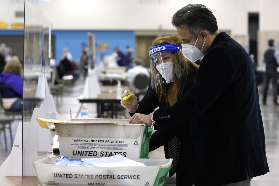 Election workers check ballots during a Milwaukee hand recount of Presidential votes at the Wisconsin Center, Friday, Nov. 20, 2020, in Milwaukee, Wis. The recount of the presidential election in Wisconsin's two most heavily Democratic counties began Friday with President Donald Trump's campaign seeking to discard tens of thousands of absentee ballots that it alleged should not have been counted. (AP Photo/Nam Y. Huh)