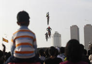 Spectators watch as freestyle motocross stunt riders from Red Bull X-Fighters perform during their show at Galle Face Green in Colombo July 30, 2011. REUTERS/Dinuka Liyanawatte