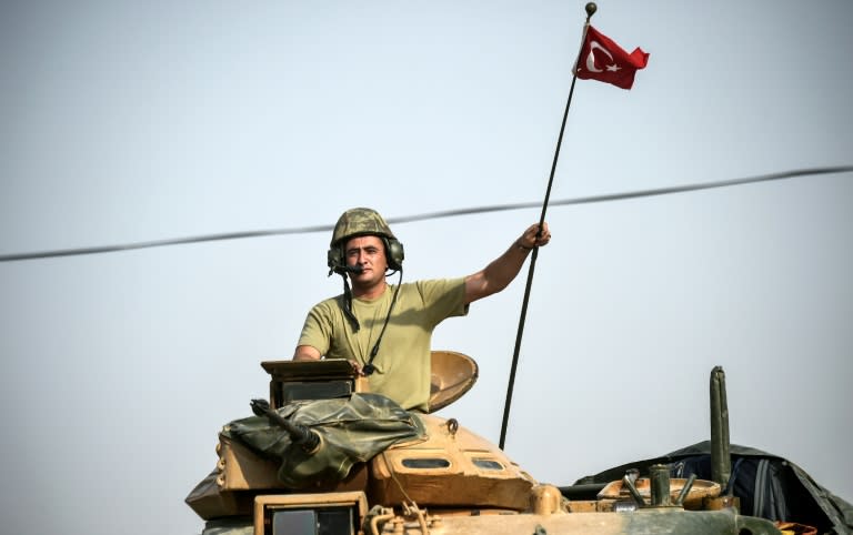 Turkish Army tanks drive to the Syrian Turkish border town of Jarabulus on August 25, 2016