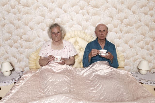 Old couple drinking tea in bed