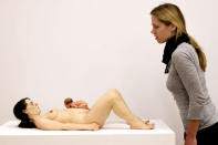 A young woman watches the sculpture 'Mother And Child' of artist Ron Mueck during the preview of new built Brandhorst museum on May 18, 2009 in Munich, Germany. The Brandhorst museum shows contemporary art of German collectors Udo and Annette Brandhorst. (Photo by Johannes Simon/Getty Images)