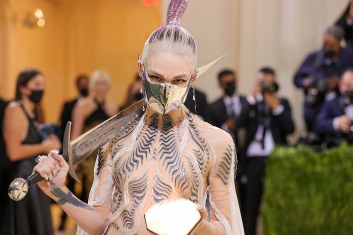 Grimes poses while holding the sword over her shoulder