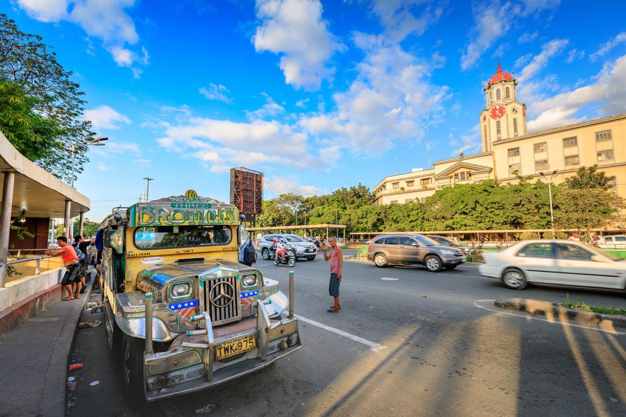 Jeepneys waiting for passengers on the street in front of Manila City Hal