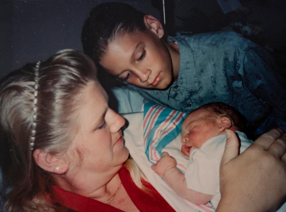 Kathi Kuykendall and son, Eric Kuykendall, are smitten with baby Asa Kuykendall in this 1993 photo.