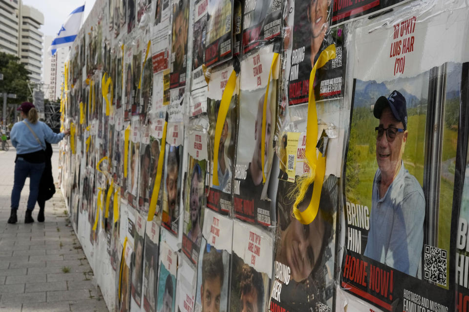 A picture of rescued hostage Louis Har hangs on a wall in Tel Aviv, Israel, Monday, Feb. 12, 2024. The Israeli military has rescued two hostages from captivity in the Gaza Strip. It identified them as Fernando Simon Marman and Louis Har. It says both men were kidnapped by Hamas militants from Kibbutz Nir Yizhak in the Oct. 7 cross-border attackd by Hamas' Oct. 7 attack into Israel. (AP Photo/Ariel Schalit)