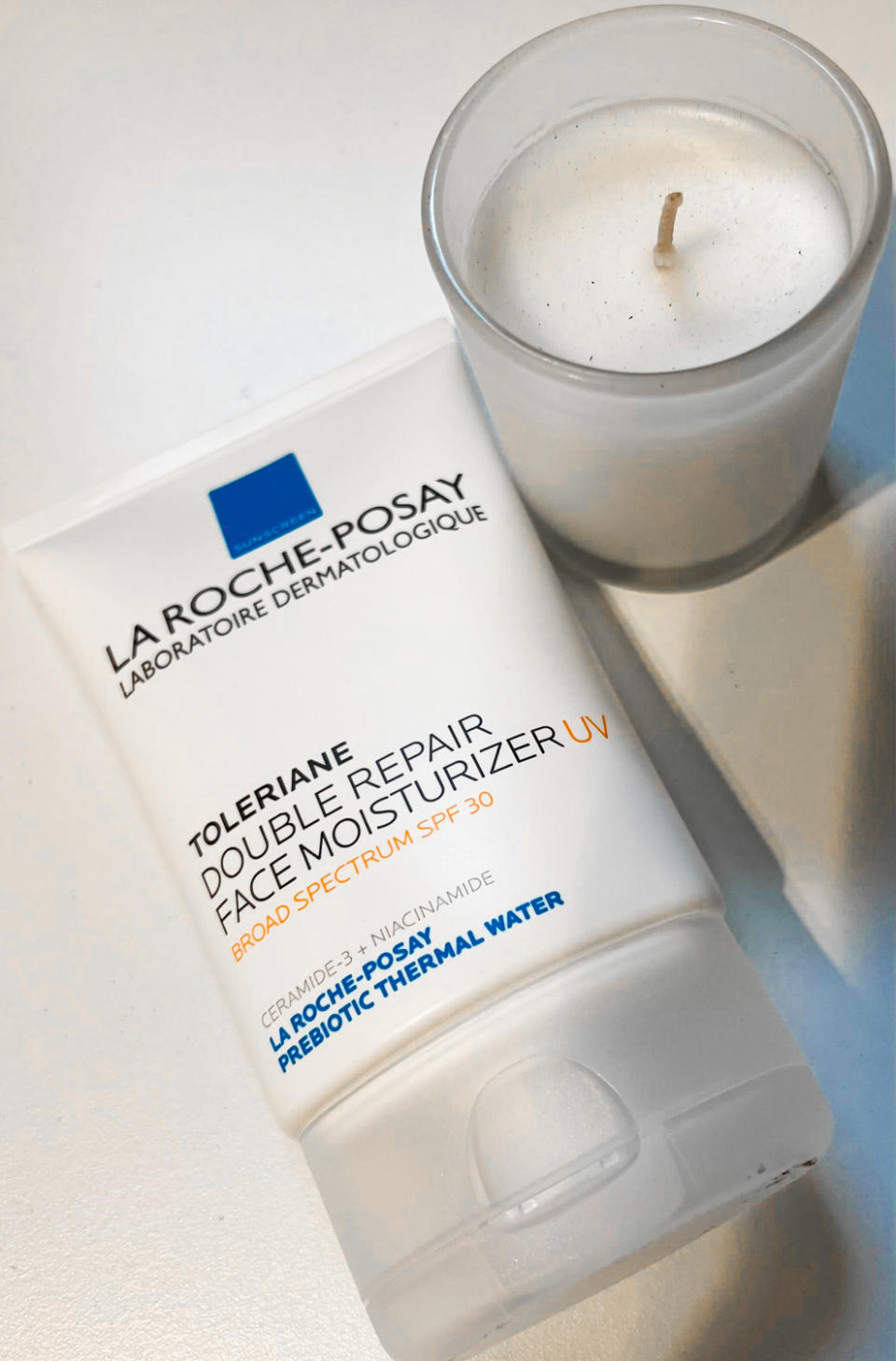 la roche posay spf moisturizer next to a candle