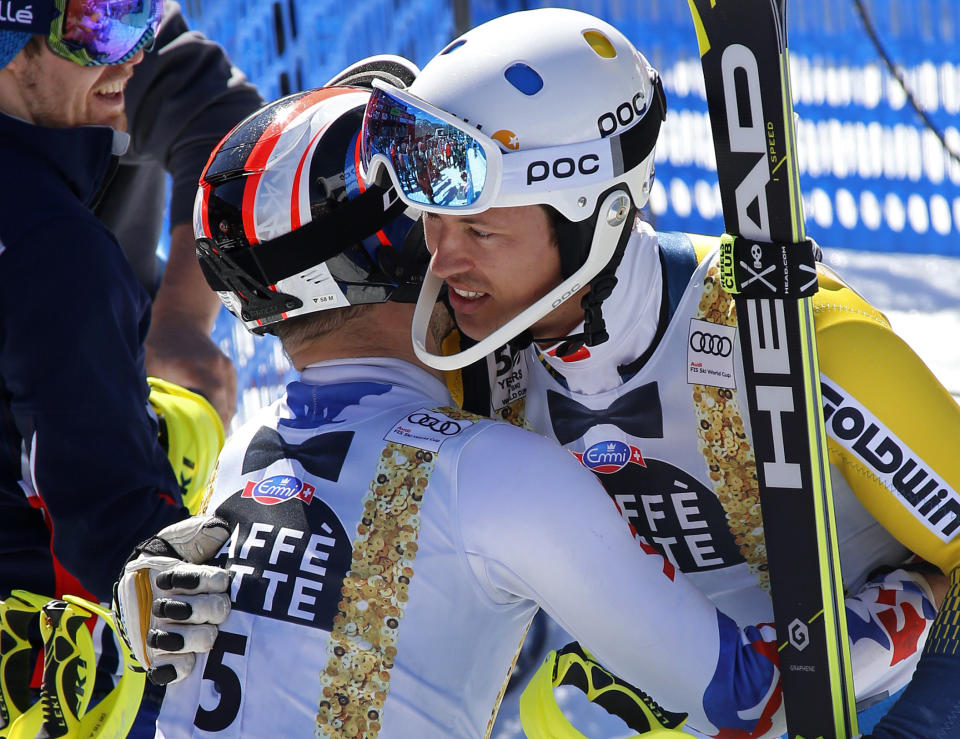 Russia's Alexander Khoroshilov, left, hugs Sweden's Andre Myhrer after the second run of a men's World Cup slalom ski race Sunday, March 19, 2017, in Aspen, Colo. (AP Photo/Nathan Bilow)