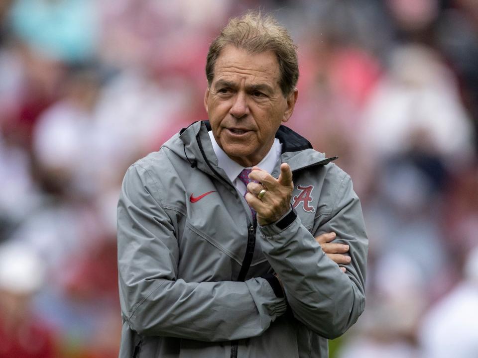 Nick Saban folds his arm and points during a scrimmage in 2022.