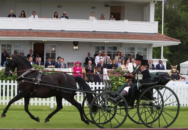 The Queen looks on as carriage drivers parade during in front of the royal box (Steve Parsons/PA)