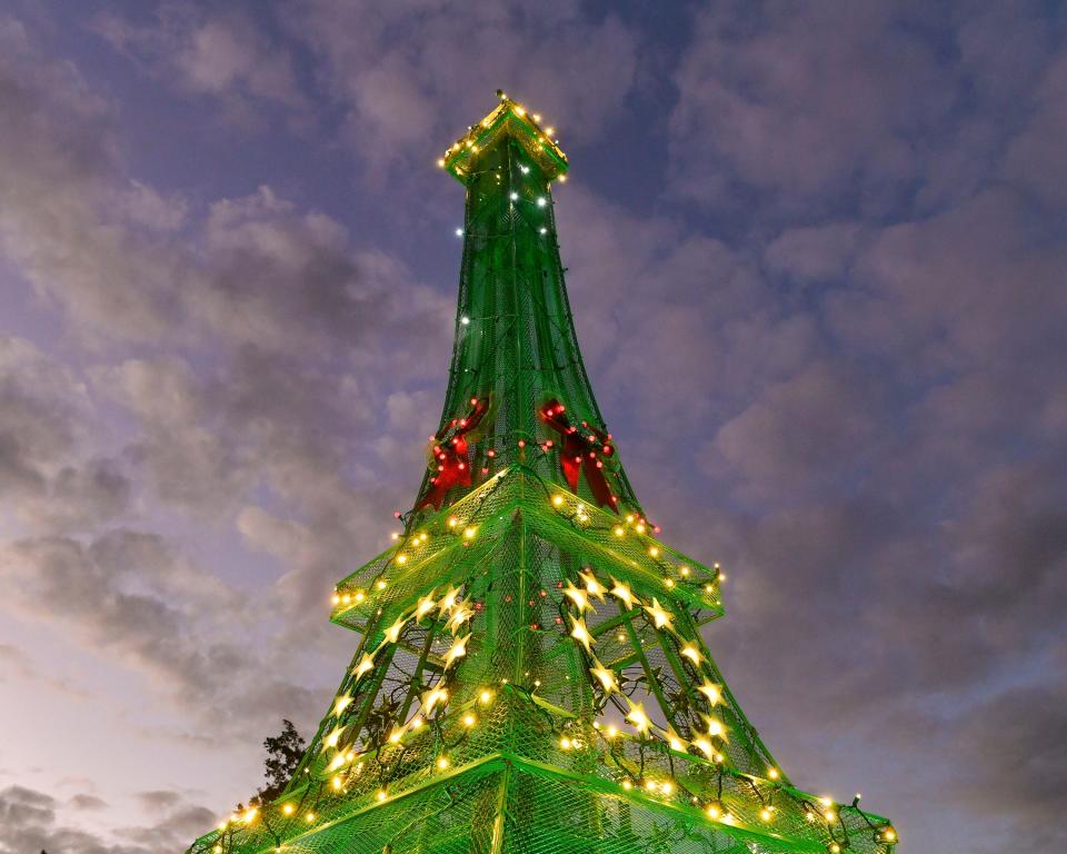 Jim and Susanne LoPilato give a tour of their yard Christmas decorations and the 12.5-foot replica of the Eiffel Tower at the roundabout at Dixie Highway and Martin Avenue near their home, Thursday, Dec. 8, 2022, in Rio. It took Jim roughly 80 hours to build the tower. "He doesn't want to go to Paris so he brought Paris to me," said Susanne. The family also decorated 25 street lights heading in all directions from the roundabout, making them look like giant candy canes.