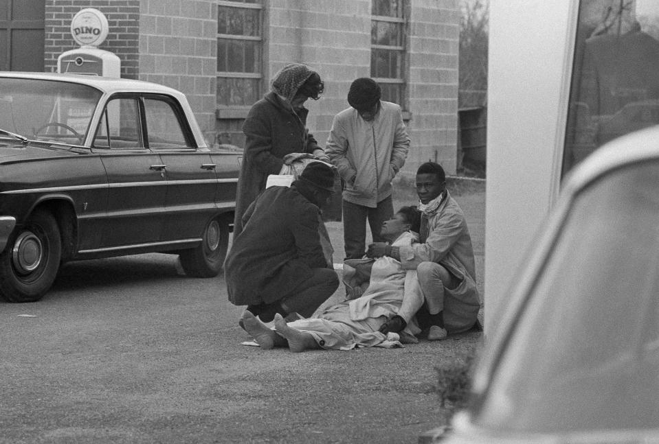 Amelia Boynton is aided by people after she was injured when state police broke up a demonstration march in Selma, Ala., March 7, 1965. During a commemoration of the 1965 voting rights marches from Selma to Montgomery, Alabama, Elliott Smith's great-aunt pushed him across the iconic Edmund Pettus Bridge in a stroller. Decades later, just before her passing, Smith switched roles and guided her wheelchair across the same bridge in 2015. She was Amelia Boynton Robinson, who helped lead the 1965 march. Now, at 27, Smith himself is in Selma leading a multiracial delegation of millennial and Gen Z activists with the intention of reshaping the ongoing voting rights debate around their generations’ access to political power and socioeconomic justice. (AP Photo)