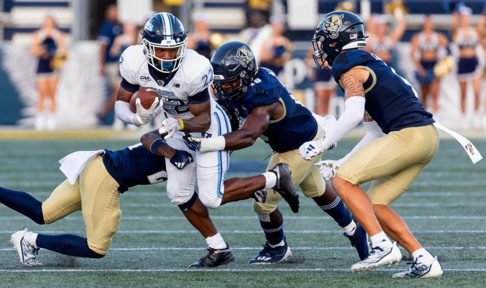 FIU Panthers linebacker Donovan Manuel (10) tackles Maine Black Bears running back Tristen Kenan (22) in the first quarter of their NCAA DI football game at the FIU Football Stadium on Saturday, Sept. 2, 2023, in Miami, Fla.