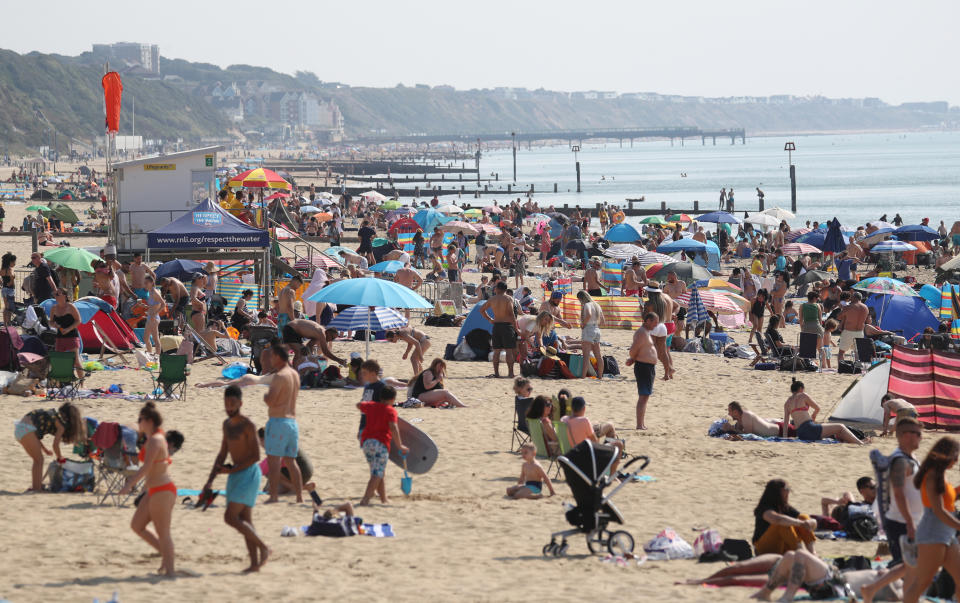 People enjoy the hot weather at Bournemouth beach in Dorset. (Photo by Andrew Matthews/PA Images via Getty Images)