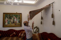 A man points to a wall, perforated with bullets holes, in an apartment after the deadly clashes that erupted last Thursday along a former 1975-90 civil war front-line between Muslim Shiite and Christian areas, in Ain el-Rumaneh neighborhood, Beirut, Lebanon, Tuesday, Oct. 19, 2021. The shootout on the streets of Beirut between rival Christian and Muslim groups has revived memories of the country's 1975-90 civil war and fired up sectarian passions in a country that never dealt with the causes of its violent past. (AP Photo/Hassan Ammar)