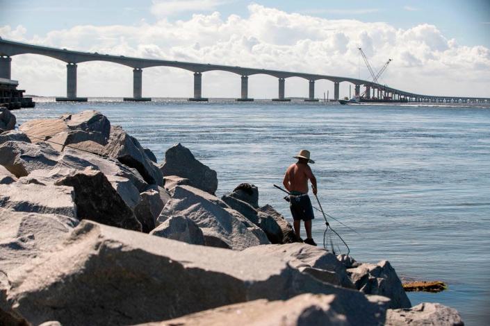 Jesse Garcia fishes the Oregon Inlet at the base of the Marc Basnight Bridge on Tuesday, June 29, 2021 in Rodanthe, N.C.