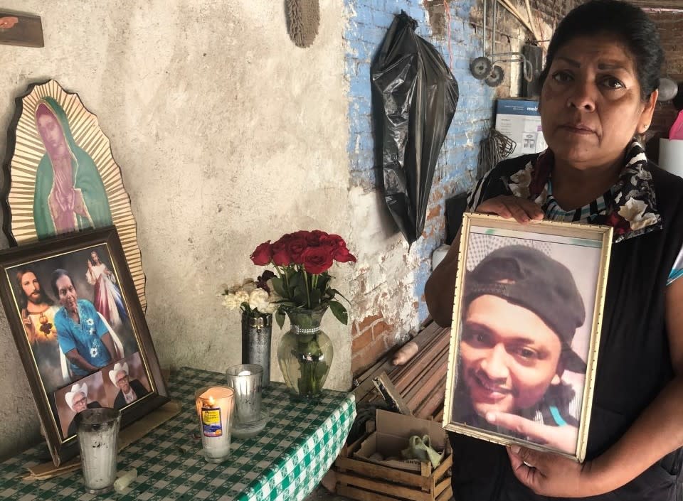 Natalia Acosta Medina holds a photo of her son, Marco Antonio Castillo Medina.