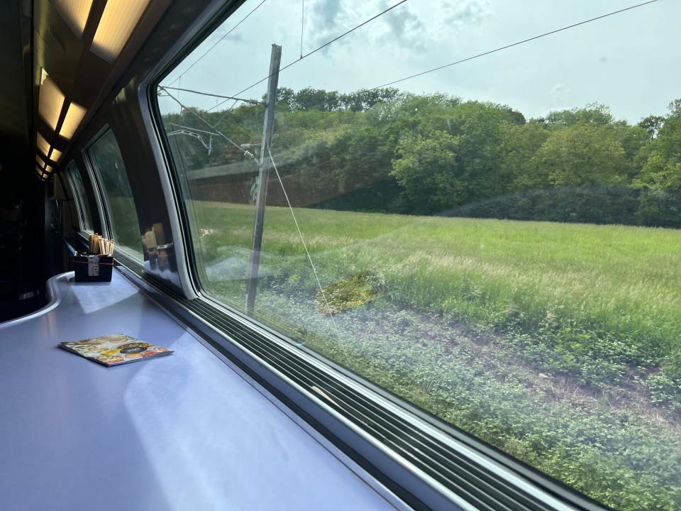 A view out the window and a table on the TGV Lyria café car