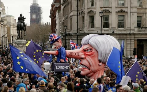 An effigy of British Prime Minister Theresa May is wheeled through Trafalgar Square - Credit: AP