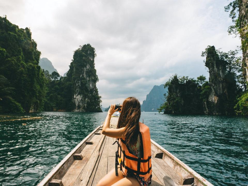 A tourist explores tourist exploring Khao Sok National Park in Thailand.