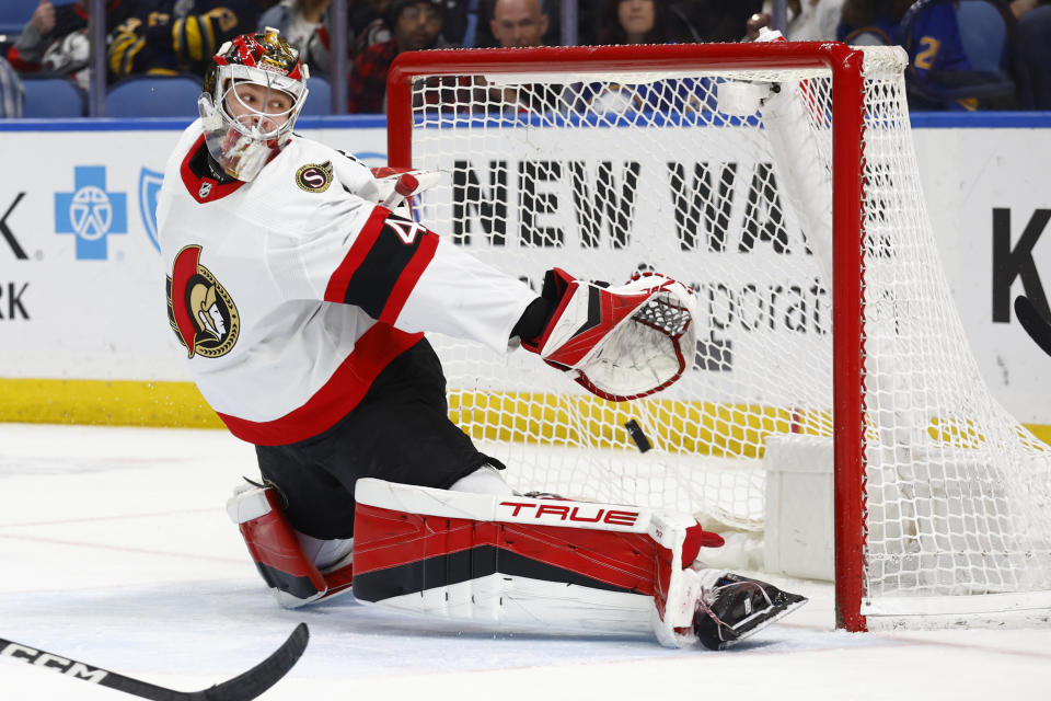 Ottawa Senators goaltender Mads Sogaard (40) reaches for the puck during the first period of an NHL hockey game against the Buffalo Sabres, Thursday, April 13, 2023, in Buffalo, N.Y. (AP Photo/Jeffrey T. Barnes)