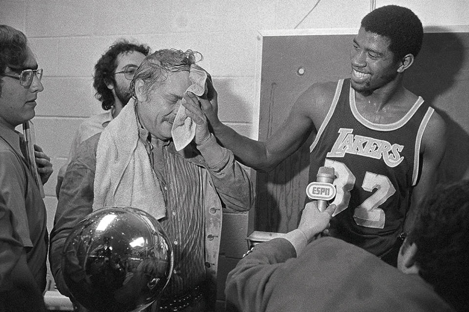 Johnson mopped up Buss after the Lakers eliminated the Sixers in six during the 1980 NBA Finals. - Credit: BETTMANN/GETTY IMAGES