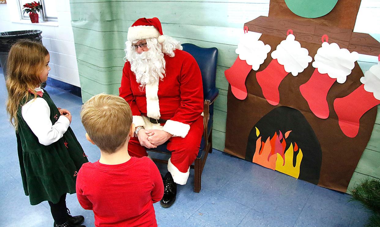 Herizyn and Hudon Farley talk with Santa at the breakfast with Santa at Mapleton Elementary School on Saturday, Dec. 4, 2021. TOM E. PUSKAR/TIMES-GAZETTE.COM