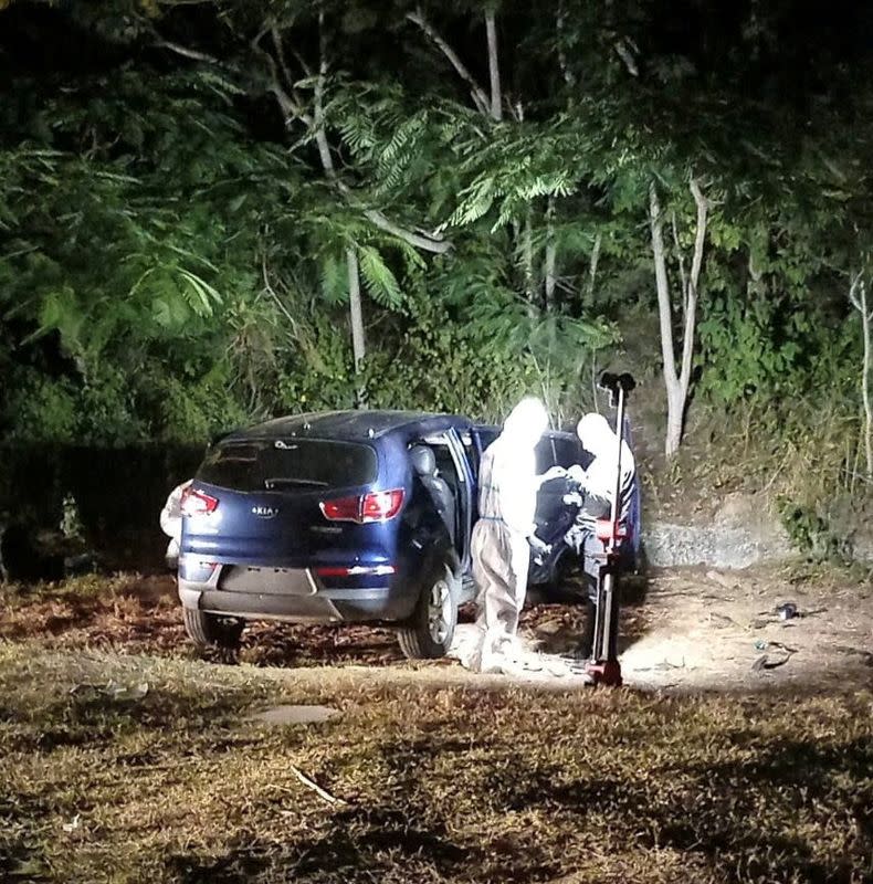 FILE PHOTO: Law enforcement officials work at the scene where Ecuador's youngest mayor, Brigitte Garcia was found shot dead in a car, according to the police, near San Vicente