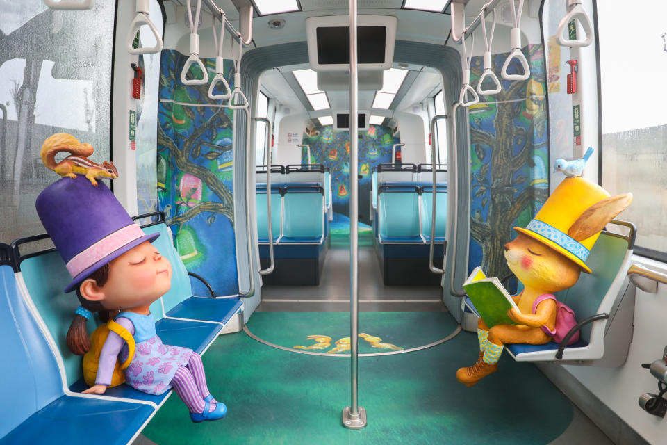 <p>The themed trains are decorated with Liao’s paintings as well as dolls inspired by the characters in Liao’s illustrative books. (Courtesy of New Taipei Metro Corporation)</p>
