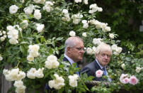 Britain's Prime Minister Boris Johnson, right, walks with Australian Prime Minister Scott Morrison after their meeting, in the garden of 10 Downing Streeet, in London, Tuesday June 15, 2021. Britain and Australia have agreed on a free trade deal that will be released later Tuesday, Australian Trade Minister Dan Tehan said. (Dominic Lipinski/Pool Photo via AP)