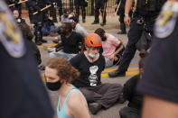 Police detain protesters, Wednesday, Sept. 23, 2020, in Louisville, Ky. A grand jury has indicted one officer on criminal charges six months after Breonna Taylor was fatally shot by police in Kentucky. The jury presented its decision against fired officer Brett Hankison Wednesday to a judge in Louisville, where the shooting took place. (AP Photo/John Minchillo)