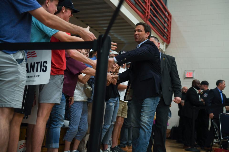 Gov. Ron DeSantis, R-Fla., high-fives voters as he walks toward the stage during his campaign stop at Riverview Park Activities Center in North Augusta, S.C.