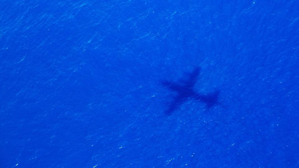 Ein Schatten eines Fliegers über dem Indischen Ozean, der nach dem Malaysia Airways Flight MH370 sucht. Foto: Richard Wainwright, AAP