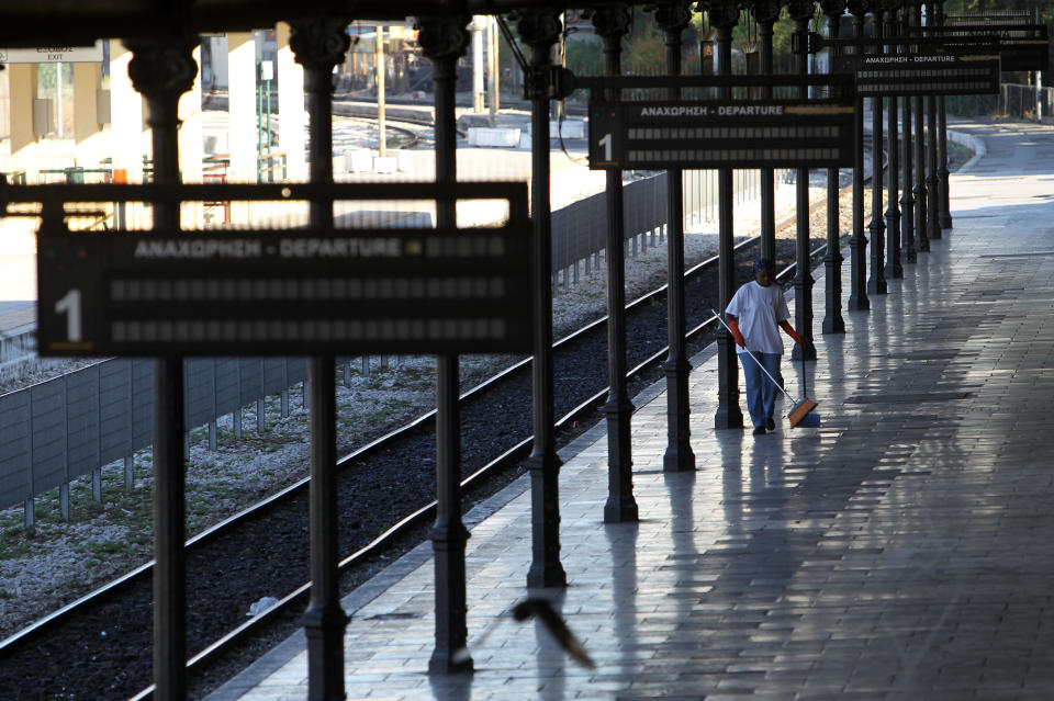 A cleaning woman is seen on the empty platform of the Athens central train station during a 48-hour nationwide general strike on Tuesday, Nov. 6, 2012. Greece's unions are holding their third general strike in six weeks in the hope of persuading politicians not to back a major new austerity program that will commit the country to further hardship. (AP Photo/Thanassis Stavrakis)