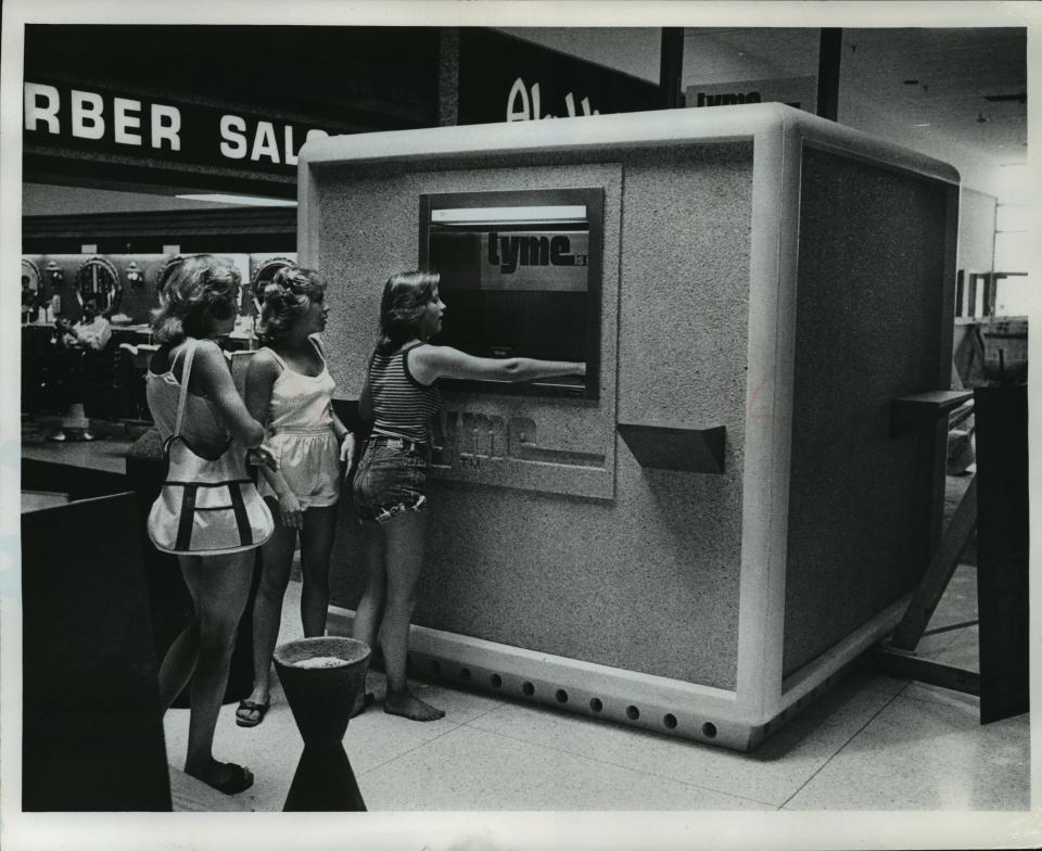 People utilize a TYME machine in 1978 at Brookfield Square. The TYME brand, an acronym for "Take Your Money Everywhere," was created in the 1970s as a partnership between four Milwaukee banks.