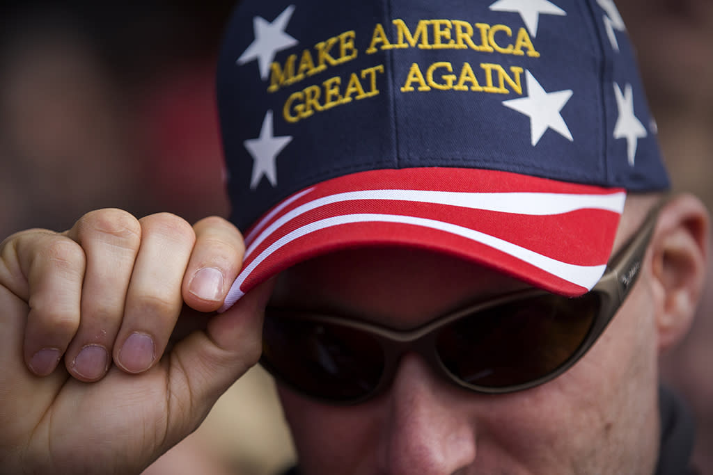 A Trump supporter dons a hat at an Ohio campaign rally. Photo from Getty Images